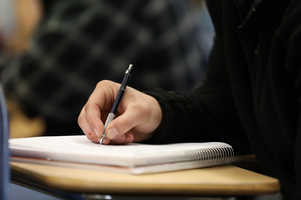 Student writing notes