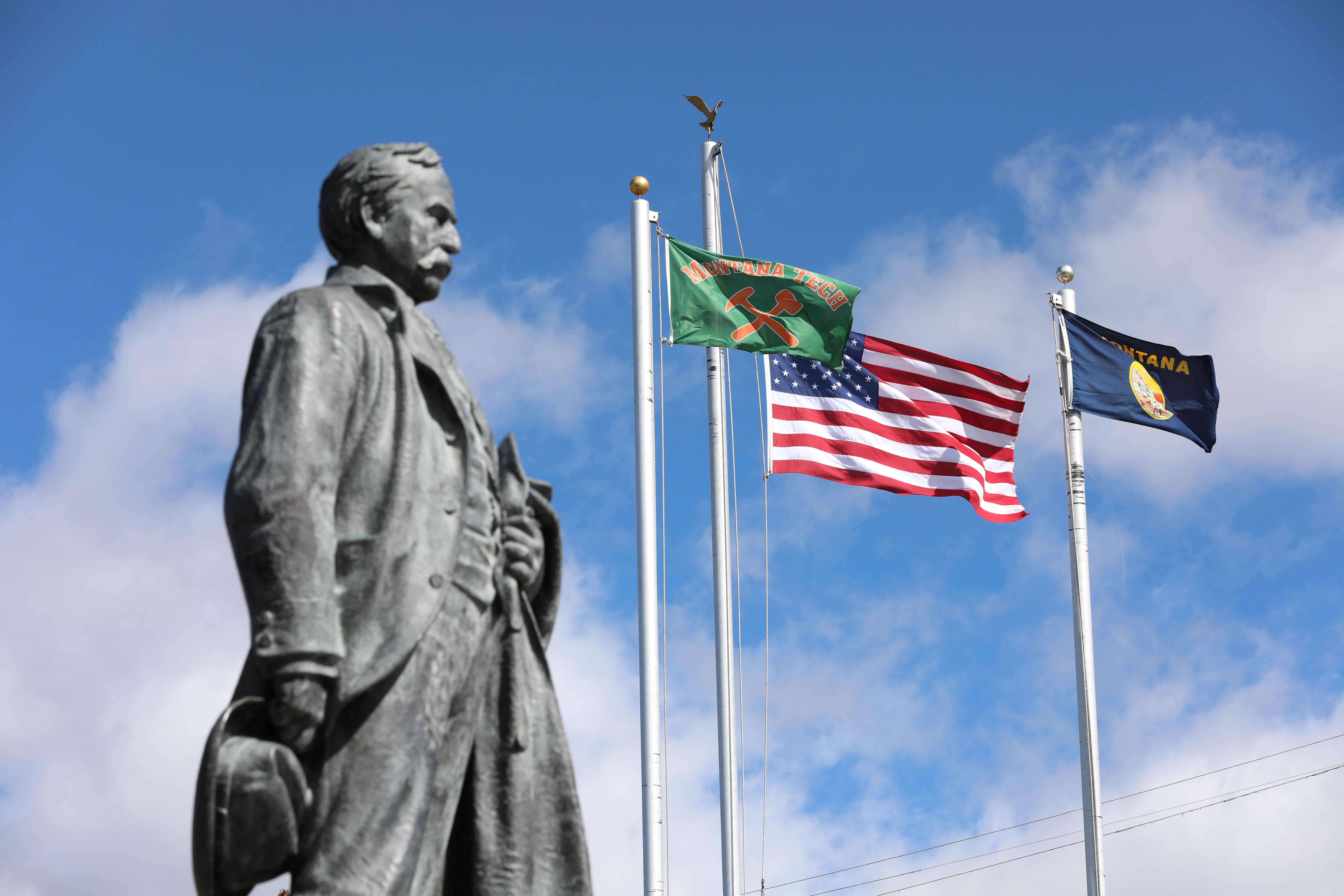 !Marcus Daly statue and Montana Tech flags