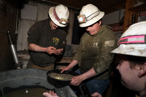 !Mining Team member pans for gold