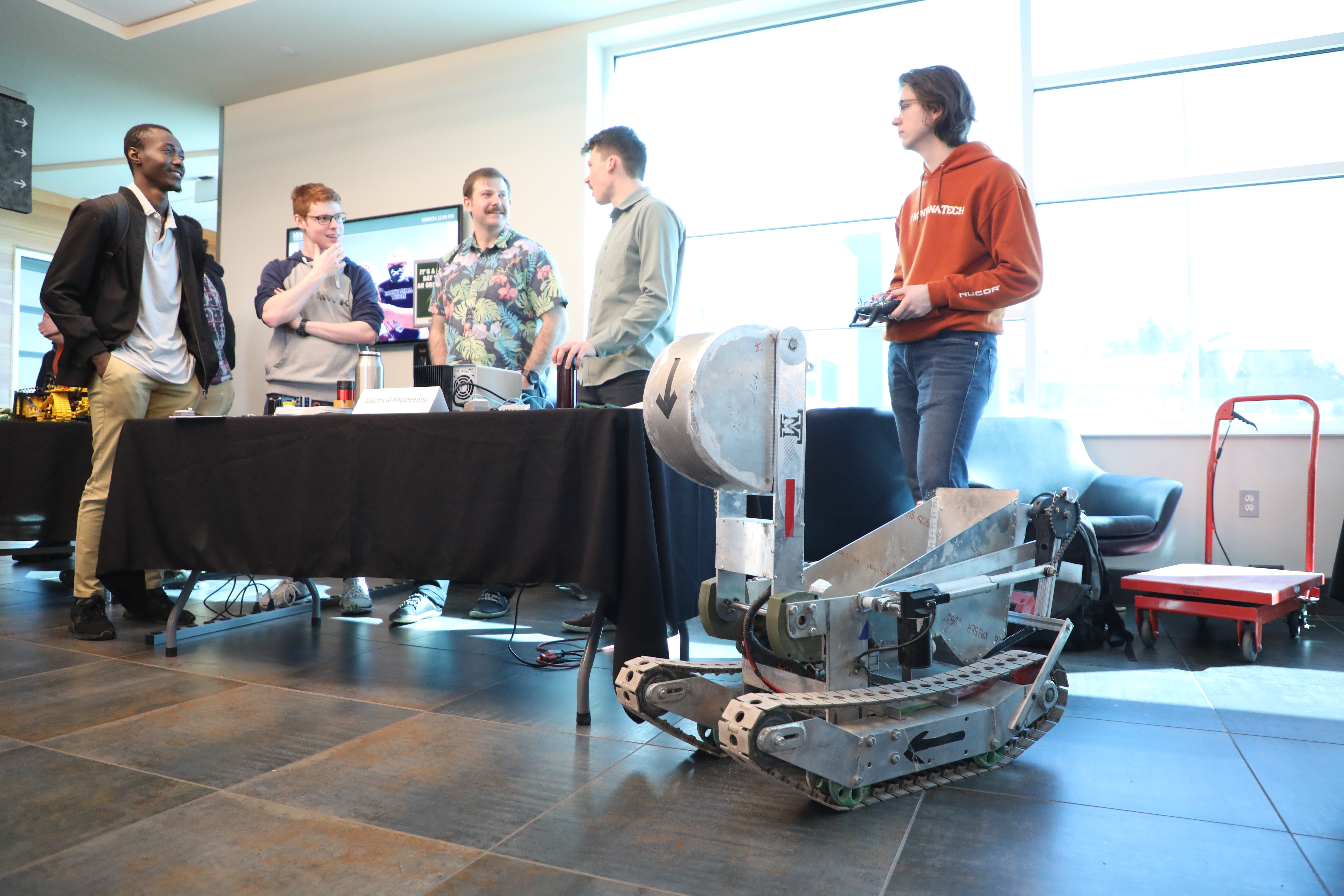 A robot sits at a Tech Day display