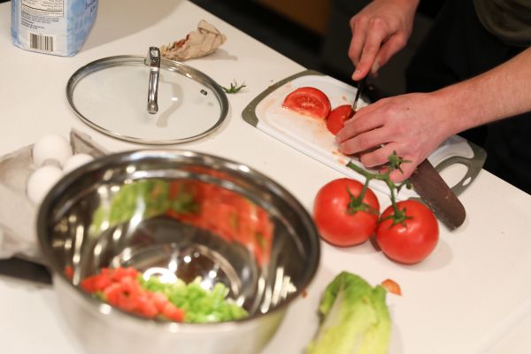 A student slices a tomato