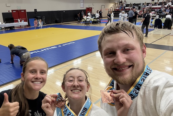!Devin Amtmann, Jade Uriarte, and Gavin Rahl pose for a photo at the Big Sky State Games